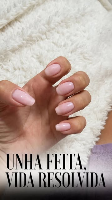 Pale pink manicure against a textured white background